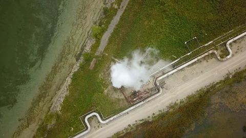 Aerial drone footage of smoke stack billowing a cloud of gas at a plant. Stock Footage 94706934