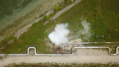 Aerial drone footage of smoke stack billowing a cloud of gas at a plant. Stock Footage 94706970