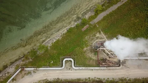 Aerial drone footage of smoke stack billowing a cloud of gas at a plant. Stock Footage 94707011