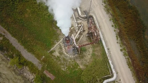 Aerial drone footage of smoke stack billowing a cloud of gas at a plant. Stock Footage 94707063