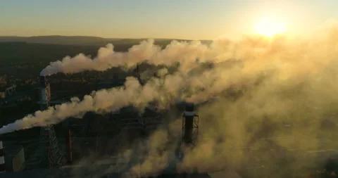 Aerial drone footage of steel factory pipes during sunset time. Top view of Stock Footage