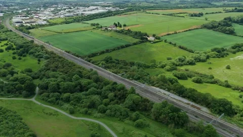 Aerial drone footage train riding through green English countryside Stock Footage 311601707