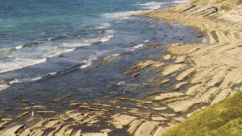 Aerial Drone Footage of waves bouncing on rocks at the beach. Beautiful blue Video stock 108611084