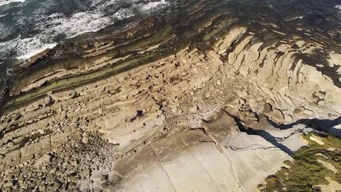 Aerial Drone Footage of waves bouncing on rocks at the beach. Beautiful blue Video stock 108611933