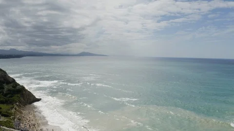 Aerial Drone Footage of waves bouncing on rocks at the beach. Beautiful blue Stock Footage 119348983