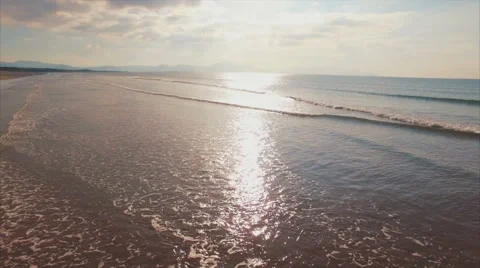 Aerial drone footage of woman standing at shore on sunny day Video stock 59082359