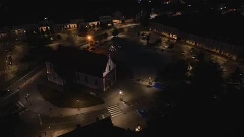 Aerial Drone Forward Flight and Descend Over Illuminated City Square Stock Footage 323769991