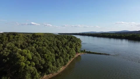 Aerial Drone Forward Flight Over Forest and River with Hills in Distance Stock Footage 313830733