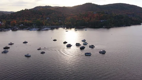 Aerial Drone Forward Flight Over Lake at Sunset with Anchored Boats Stock Footage 321378924