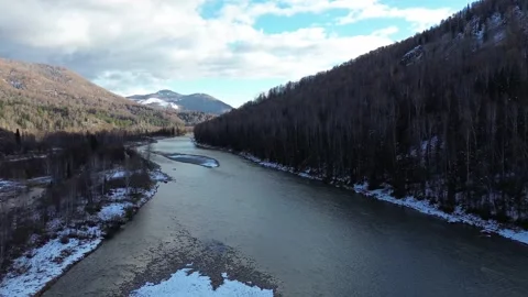 Aerial Drone Forward Flight Over a Winding River in a Snowy Valley Stock Footage 348520353