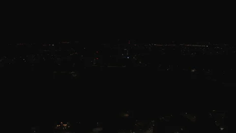 Aerial Drone Forward Flight Towards Distant City Lights at Night Stock Footage 323769648