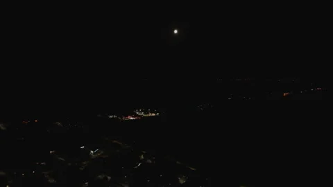 Aerial Drone Forward Night Flight Over Town with Moon in Sky Stock Footage 323769867