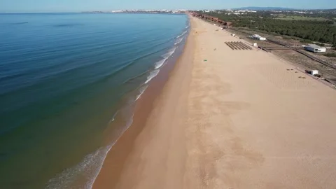 Aerial drone forward perspective of an almost empty Praia de Falesia  Stock Footage 239459246