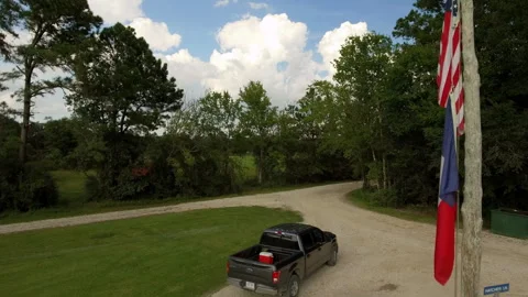 Aerial: Drone Forward Shot Of Black Pick-Up Truck Moving On Road Amidst Green Stock Footage 255190894