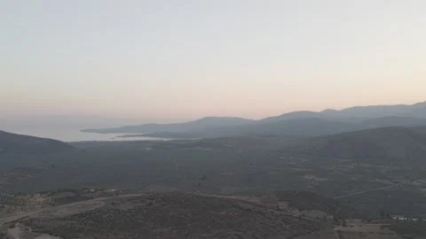 Aerial drone forward shot flying away from the sunset over the sea with Vidéo 332993594