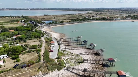 Aerial Drone Forward tracking shot of traditional fishing huts on stilts Video stock 316049394