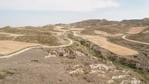 Aerial Drone forward view and tilt up of arid hills Stock Footage 129999254