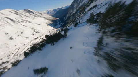 AERIAL DRONE FPV FAST DIVE OVER SNOWED ROCKY MOUNTAIN Stock Footage 170718320