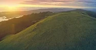 Aerial Drone Of Grass Hills On A Mountain Ridge At Sunset Flying Over People Stock Footage