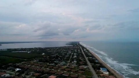 Aerial drone high angle over off shore island beach homes at dusk Stock Footage 102730418