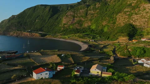 Aerial drone high-angle view of a scenic coastal village with terracotta-roofed Видео 336220969