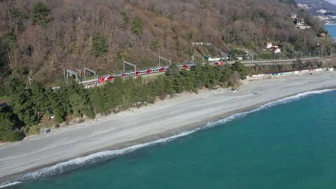 Aerial drone. High-speed train rides along the coast. Journey to the sea. Vidéo 106834363