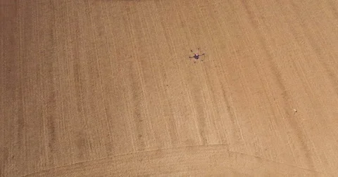 Aerial of drone hovering over field Stock Footage 64344897