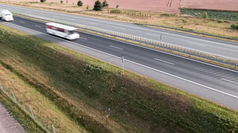 Aerial drone hyper lapse footage of cars moving fast on busy highway at sunset Stock Footage 203528293
