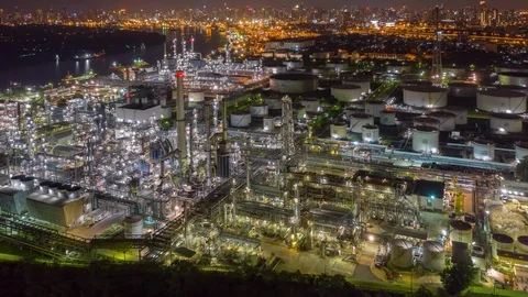 Aerial drone hyper lapse over oil refinery factory at night with city background Stock Footage 109088297
