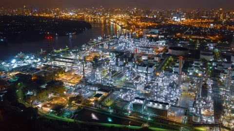 Aerial drone hyper lapse over oil refinery factory and city at night. Stock Footage 110265462