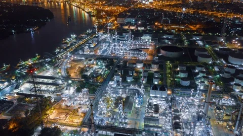 Aerial drone hyper lapse over oil refinery factory and city at night. Stock Footage 110265468