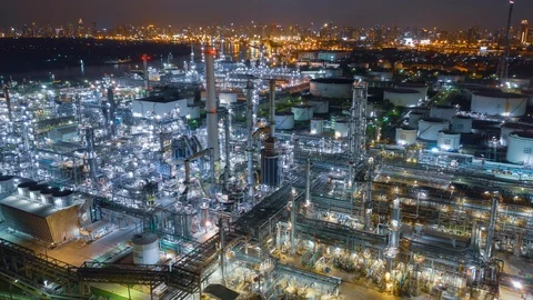 Aerial drone hyper lapse over oil refinery factory and city at night. Stock Footage 110266629