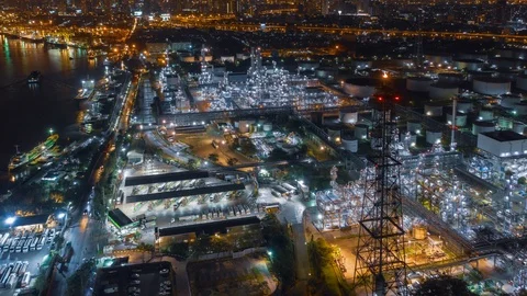 Aerial drone hyper lapse over oil refinery factory and city at night. Stock Footage 110267003