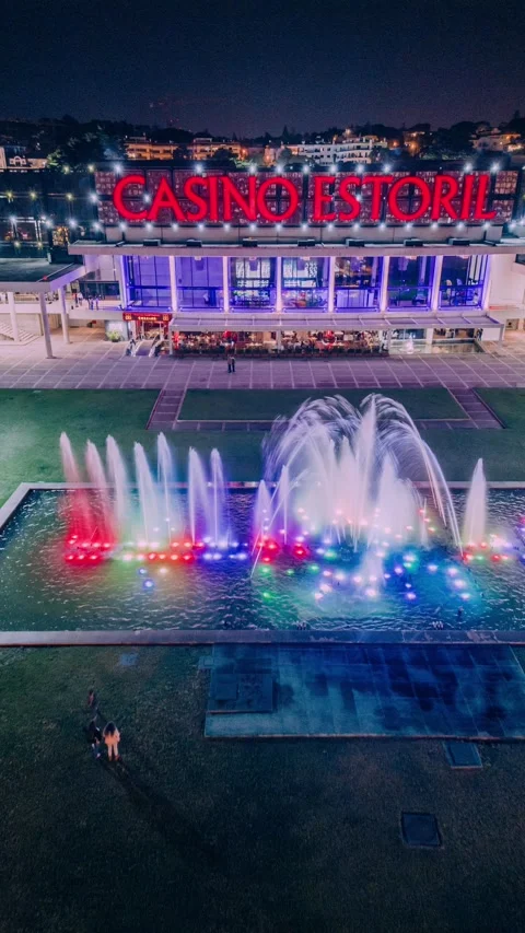 Aerial drone hyperlapse of Estoril Casino and illuminated fountain in Estoril Stock Footage 273183853