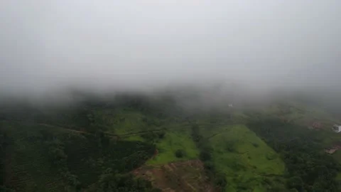 Aerial drone hyperlapse of misty gray clouds above a hill Stock Footage 229897028