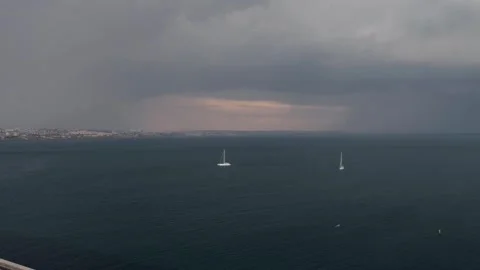 Aerial drone hyperlapse over Cascais Bay in Portugal approaching storm rain Stock Footage 242005267