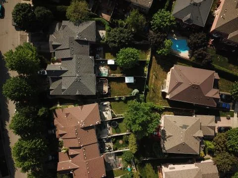 Aerial drone image (top down) of suburban houses on a sunny summer day. Stock Photos