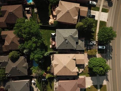 Aerial drone image (top down) of suburban houses on a sunny summer day. Stock Photos
