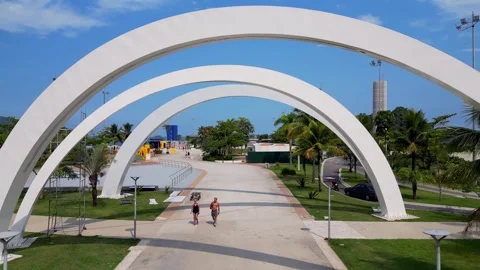Aerial drone inside modern architectural arches in public park in Santos. Stock Footage 240793832