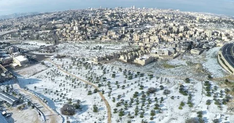Aerial drone Israel Middle Eastern city Jerusalem snow Mount Scopus lookout Stock Footage 79078633