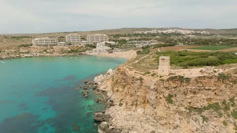 Aerial drone landscape view of tower, cliffs, sea and beach. Malta Stock Footage 246419700