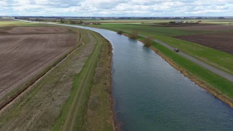 Aerial drone large river road Lincolnshire fens rural land travel England 스톡 동영상 306561693