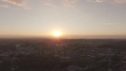 Aerial drone lateral movement to the left with sunrise over suburban city Vídeos de archivo 334556337