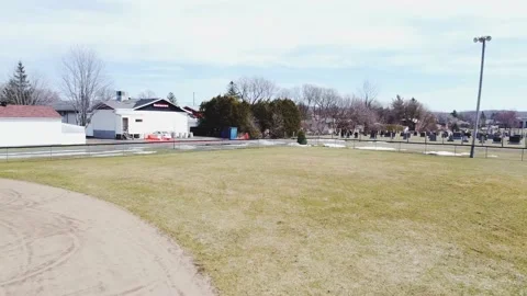 Aerial drone, low angle view, flying backward quickly over a baseball field Video stock 164798502