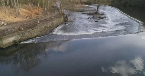 Aerial drone mini waterfall over weir in river aire, Leeds Stock-Footage 130385462