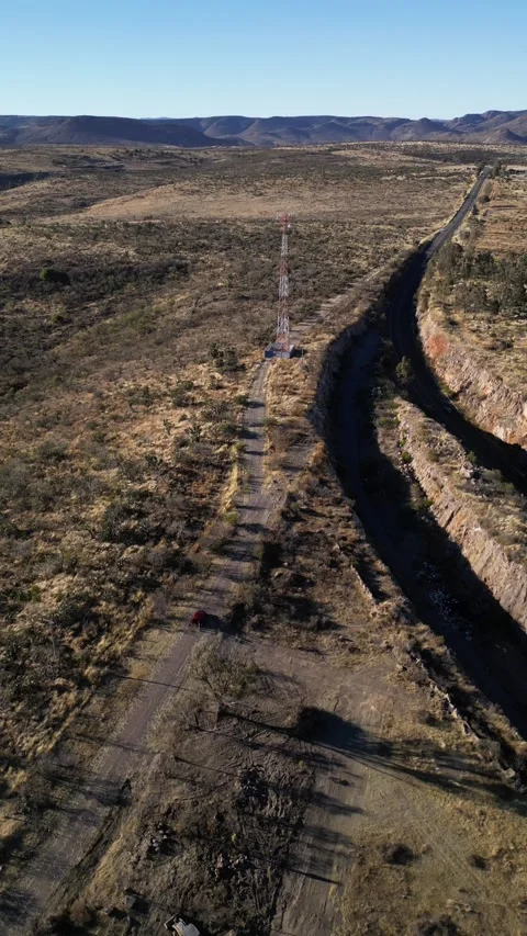 Aerial drone of a mountain road through rock and telecom tower, Mexico Stock Footage 341548068