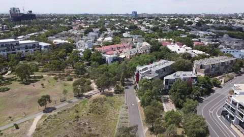 Aerial drone moves forward over leafy Kensington suburb on a sunny day Stock Footage 309020874