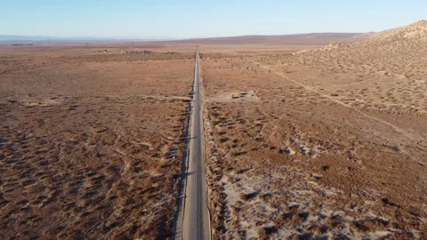 Aerial drone moving down desert road Stock Footage 147004485