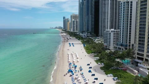 Aerial drone moving forward on the coast of Aventura in florida Stock Footage 252865550