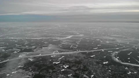 Aerial from drone moving slowly forward over a vast frozen lake Stock Footage 144854175